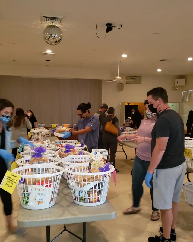 Volunteers in masks packing Thanksgiving baskets in Jaycee Hall