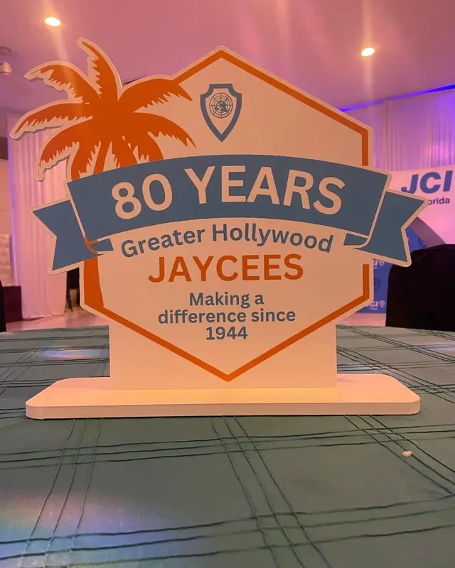 A sign reading 80 years, Greater Hollywood Jaycees, making a difference since 1944