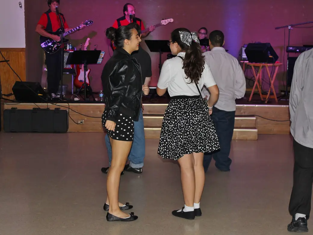 Volunteers dancing in 1950s outfits at the 2014 Sock Hop